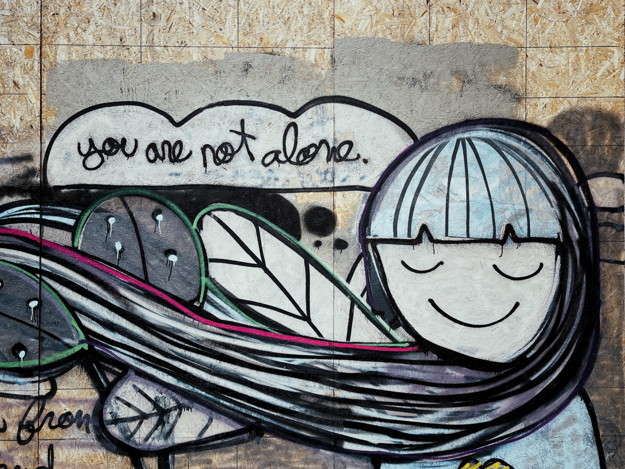 graffiti saying "You are not alone"