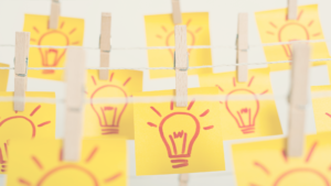 post it notes hanging with idea bulb on them
