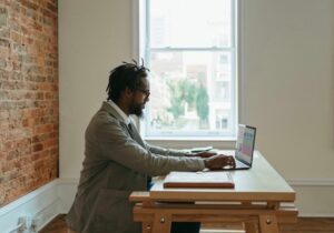 A writer sits at his laptop to get some work done